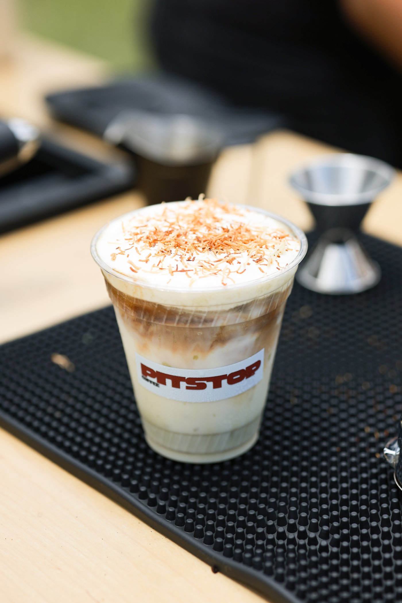 Iced Knafe Pistachio Latte topped with toasted kunafa shreds and whipped cream